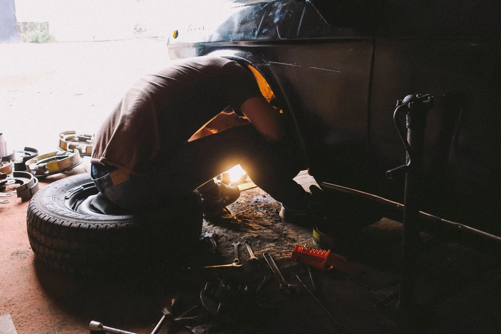 garage door repair spring replacement cost shown on a technician adjusting a torsion spring